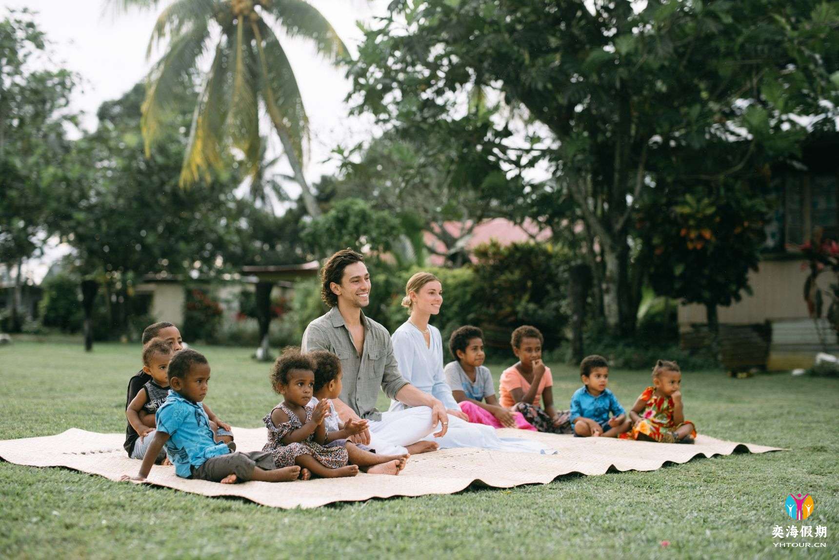 Several small children and two adults sitting on_yy.jpg